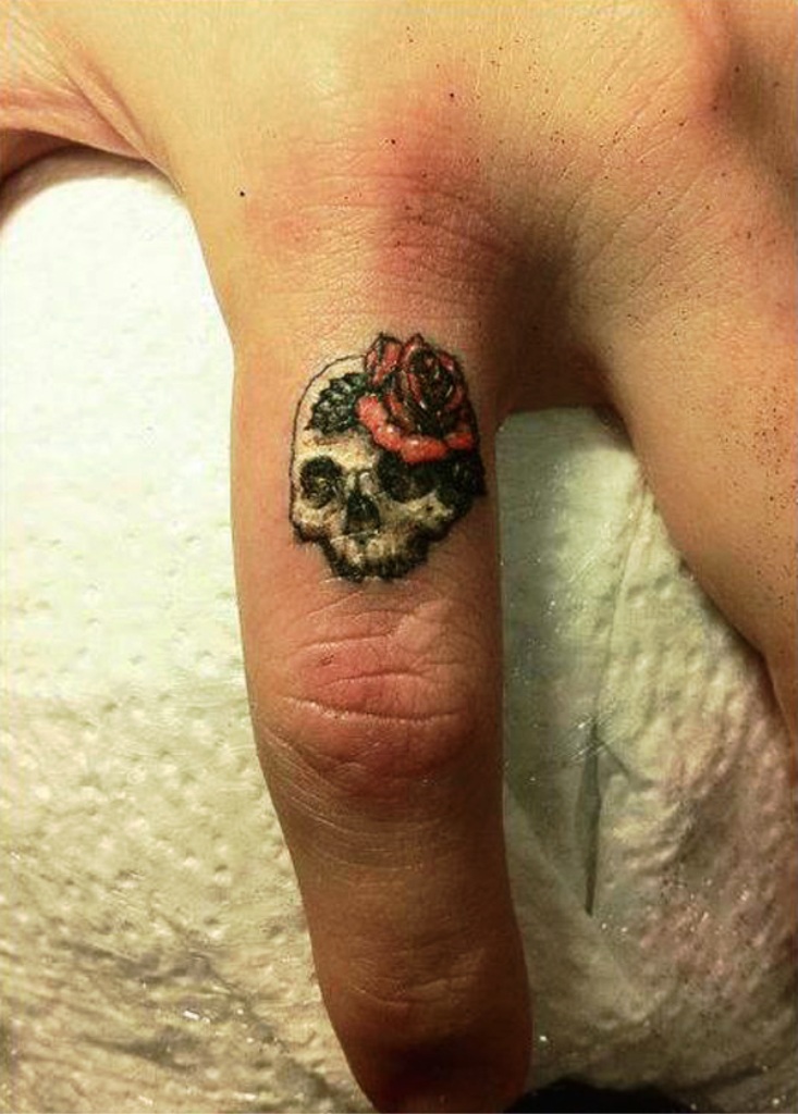 Small Skull Finger Tattoo