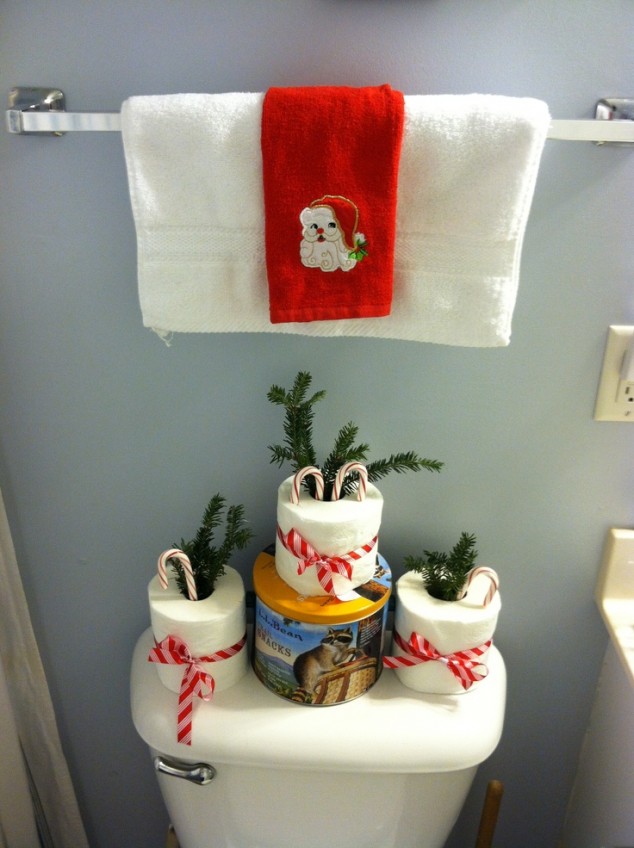 inexpensive-christmas-bathroom-decorations-with-red-santa-towel-and-paper-with-candy-cane-and-pine-leaves-with-red-ribbon-over-toilet-tank-634
